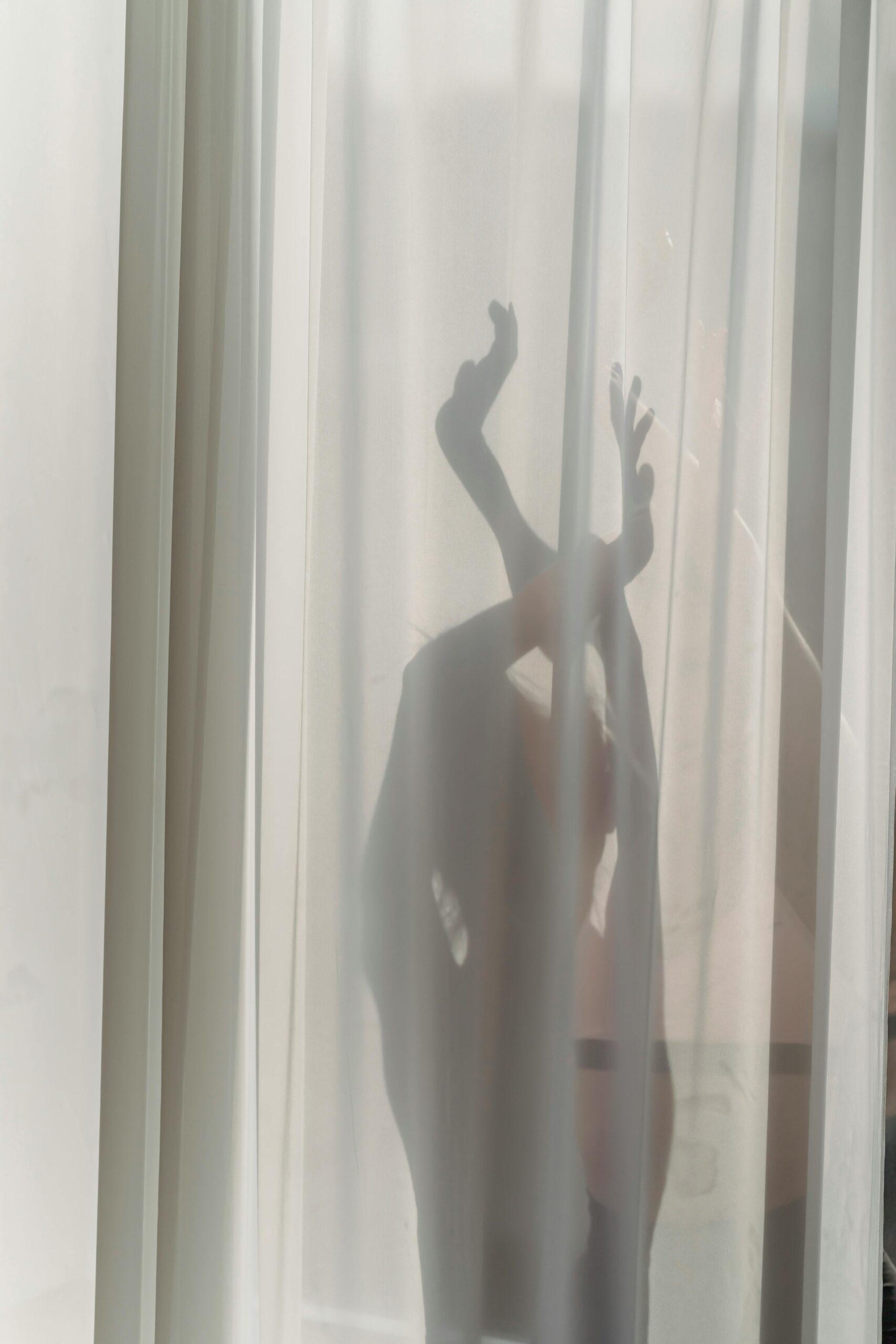 dancing woman behind curtain